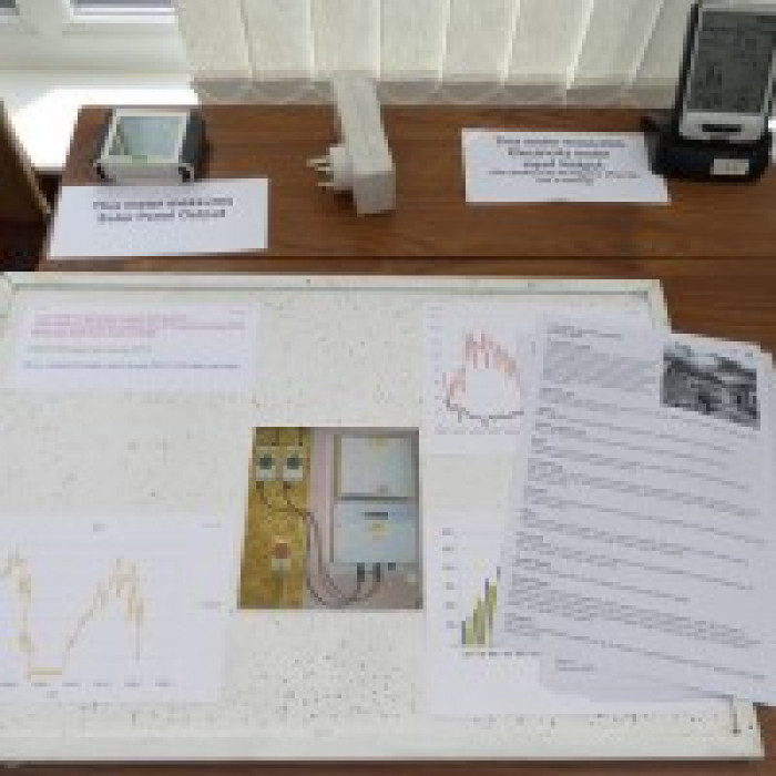 paperwork and graphs laid out on a table showing energy consumption and savings