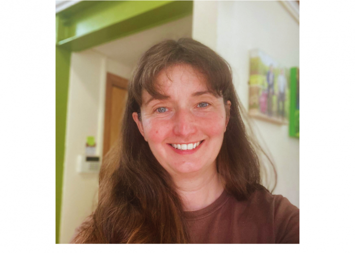 christine, a white woman with long straight dark brown hair and blue eyes